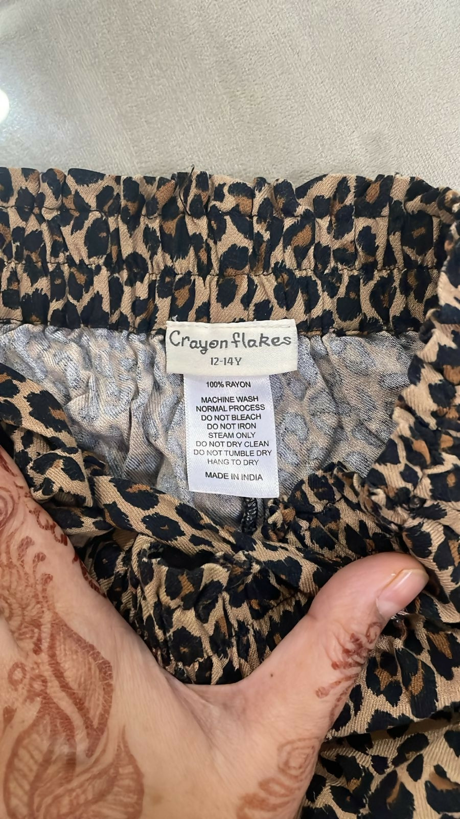 Leopard print fabric with a label on a neutral background