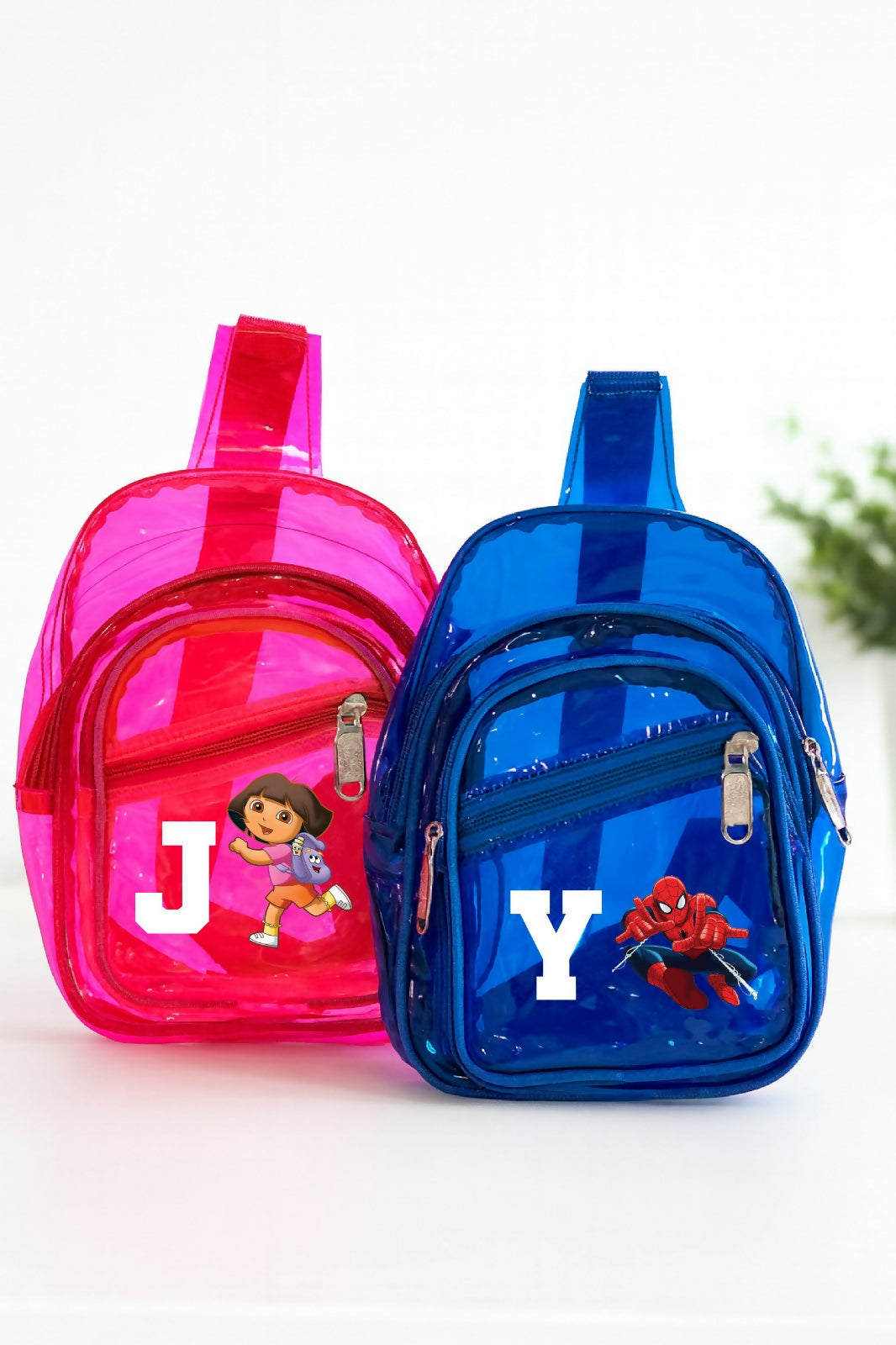 Pink and blue transparent backpacks with cartoon characters on a white background