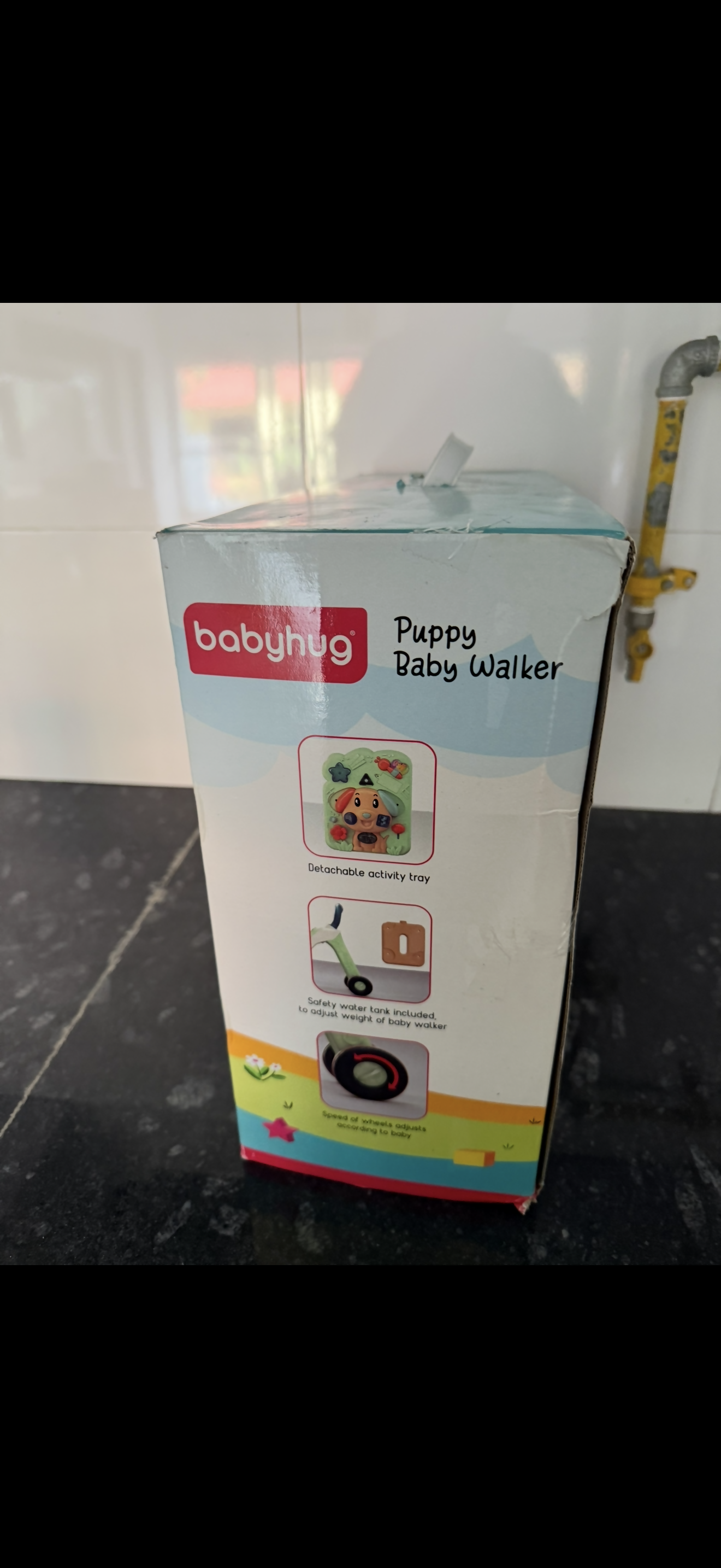 Box of baby walker with 'babyhug' branding on a dark surface.