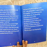 Open book with blue pages displaying text on a textured surface