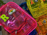 Clear plastic bags with colorful letter decorations in various colors.