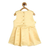 Yellow dress on a wooden hanger against a white background