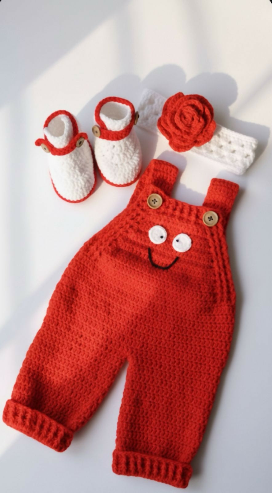 Red knitted baby outfit with booties, and headband