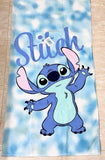 Towel with cartoon character 'Stitch' on a blue and white cloud pattern
