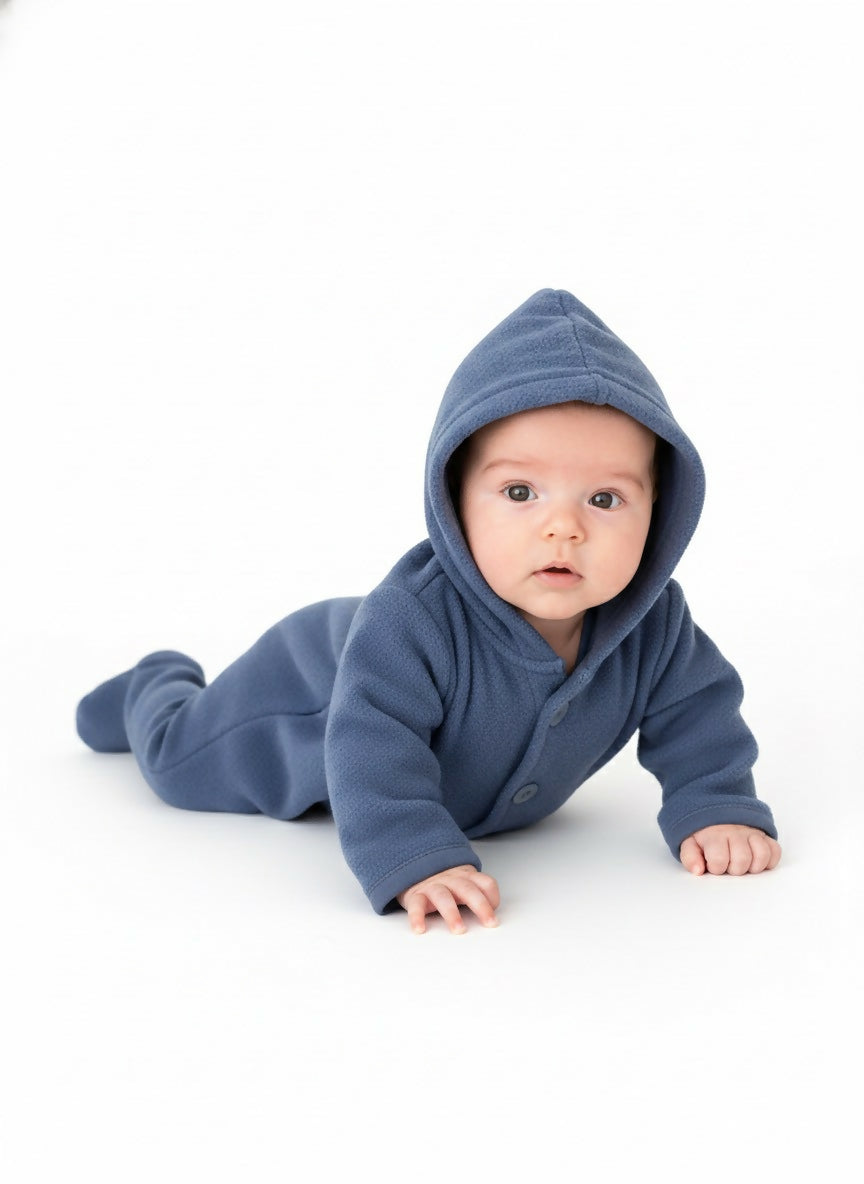 Baby wearing a blue hooded onesie