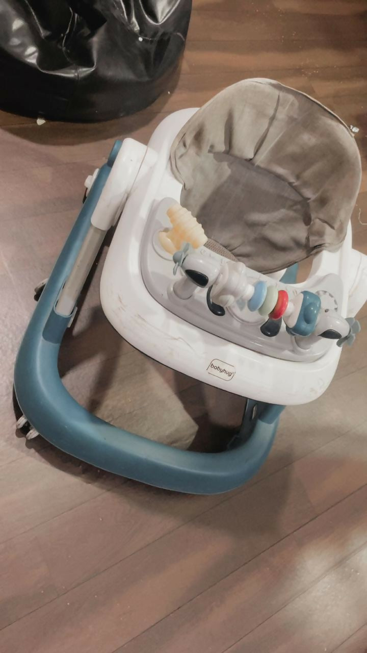 BABYHUG baby walker with sturdy frame, padded seat, and toy tray for safe first steps.