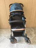 Blue and black stroller with rose gold accents