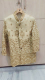 Embroidered traditional outfit on a hanger against a light background