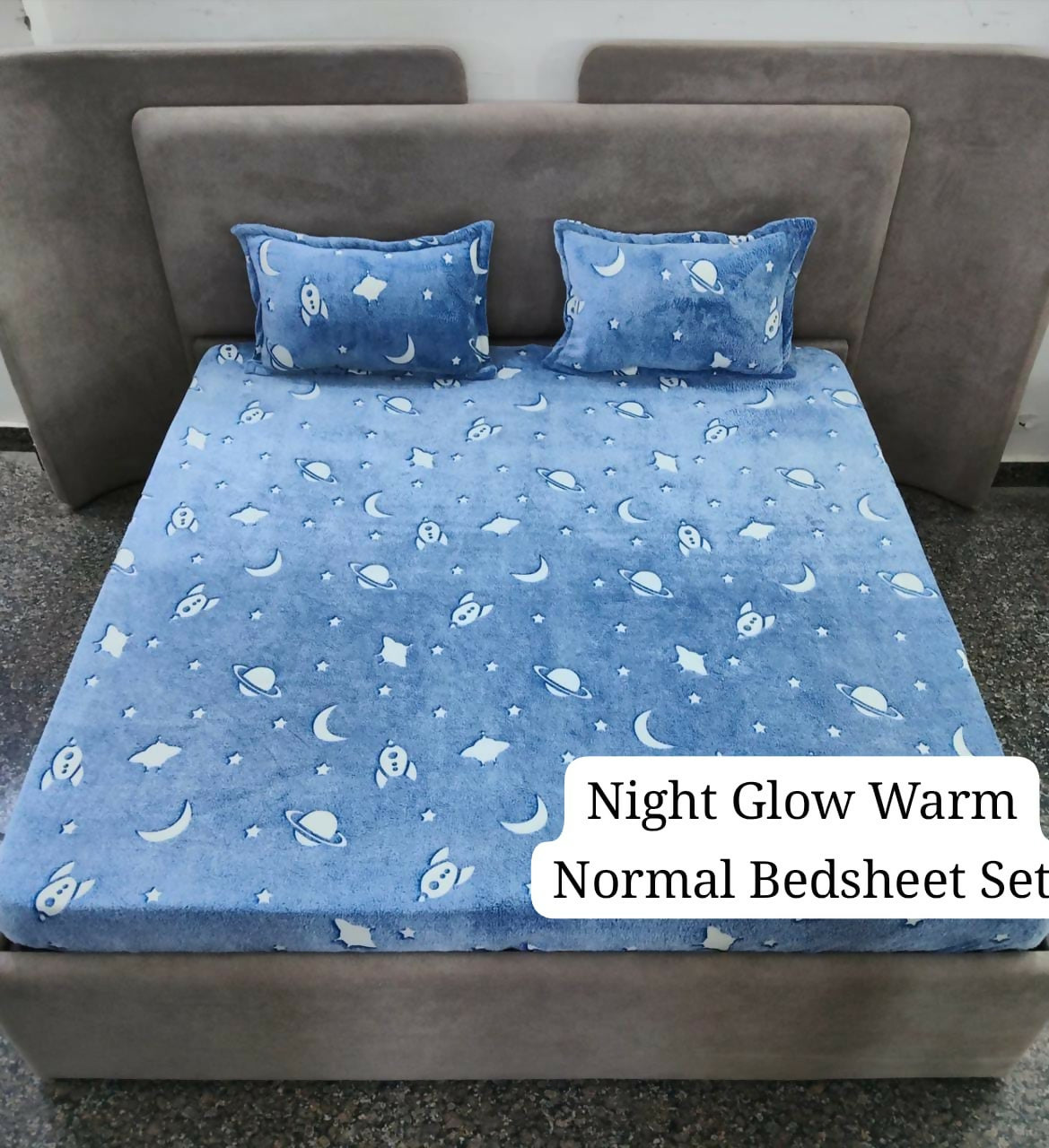 Blue night glow warm normal bedsheet set with star and moon pattern on a bed.