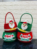Two Christmas-themed baskets with Santa faces and 'Merry Christmas' text