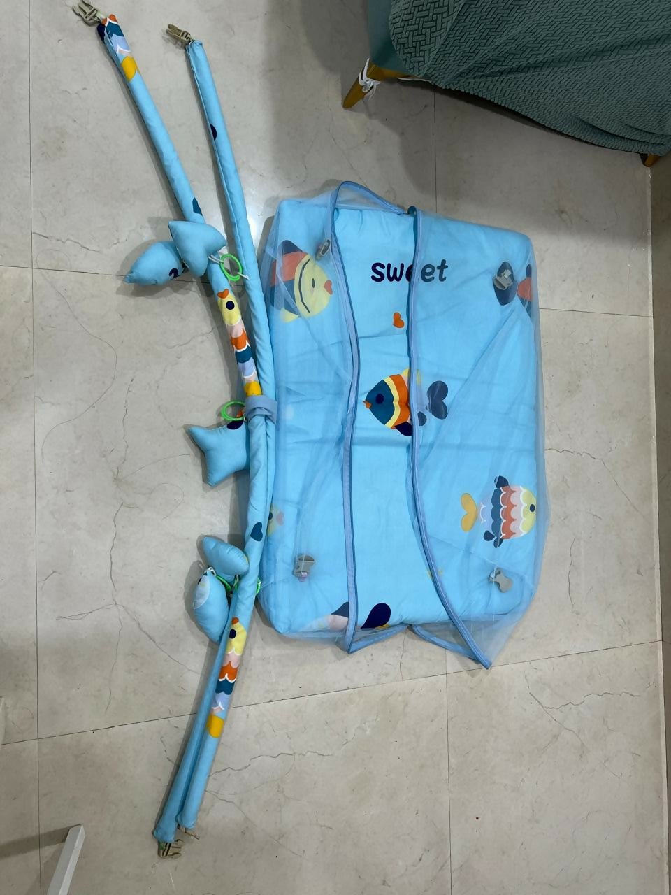 Baby bed with hanging toys featuring a soft cushioned asleeping area, protective sides, and colorful hanging toys to keep babies comfortable, engaged, and entertained.