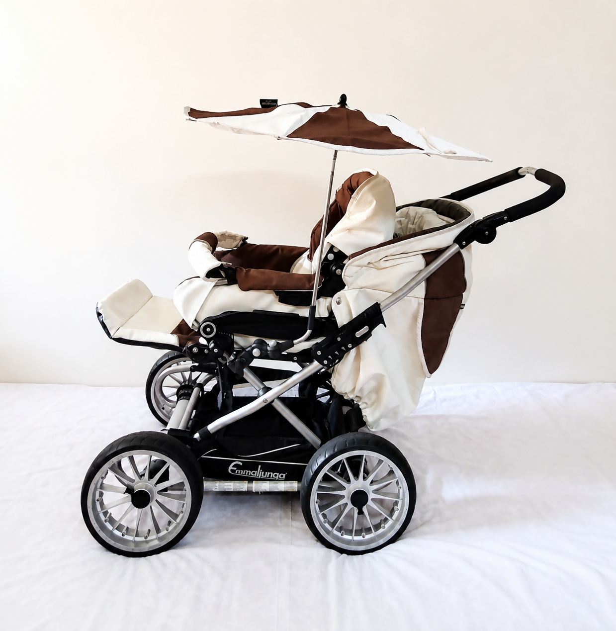 Emmaljunga City Cross Premium Stroller B128 in Almost New condition, available in Chennai, Tamil Nadu, featuring a reversible seat, comfortable reclining design, protective canopy, rain cover, sturdy frame, and smooth wheels.