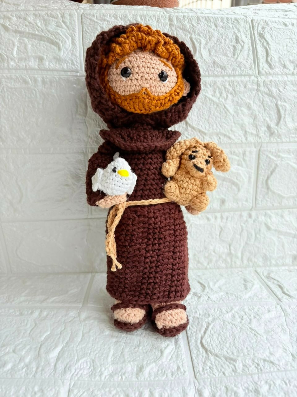 Handmade St. Francis of Assisi crochet doll crafted from soft yarn with detailed stitching, a gentle expression, and a charming design for gifting, collecting, or nursery décor.