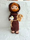 Handmade St. Francis of Assisi crochet doll crafted from soft yarn with detailed stitching, a gentle expression, and a charming design for gifting, collecting, or nursery décor.