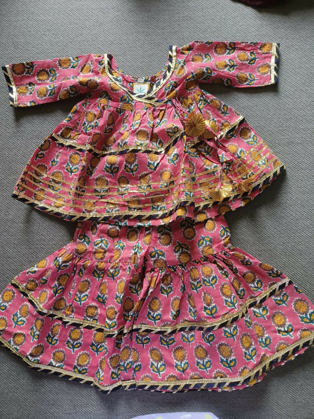 Enhance your baby girl's festive wardrobe with the TEENTARE Kurta and Sharara Set – a charming and comfortable outfit perfect for special occasions, featuring vibrant colors and intricate designs.