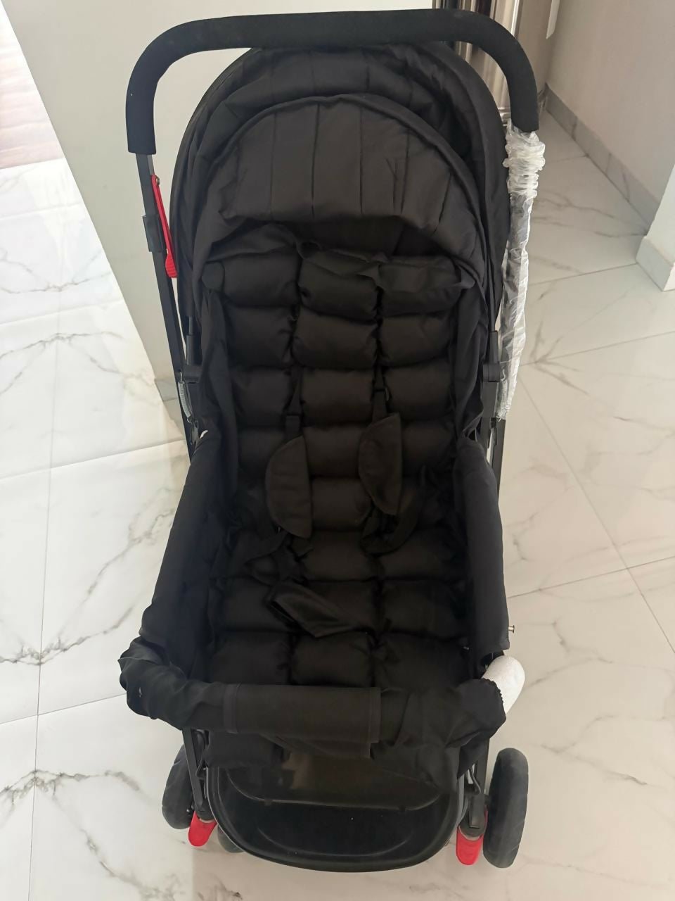 BABYHUG Cocoon stroller/pram with a reclining seat, foldable design, adjustable canopy, 5-point safety harness, smooth wheels, and storage basket for comfortable travel with babies and toddlers.