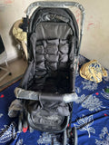 BABYHUG Cocoon stroller with mosquito net, reclining seat, safety harness, protective canopy, smooth wheels, and comfortable travel design for babies.