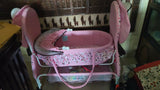 BABYHUG Froggy Print cradle with soft bedding, protective mosquito net, swing lock function, sturdy frame, and adorable frog print for a safe and comfortable sleeping space for newborns.