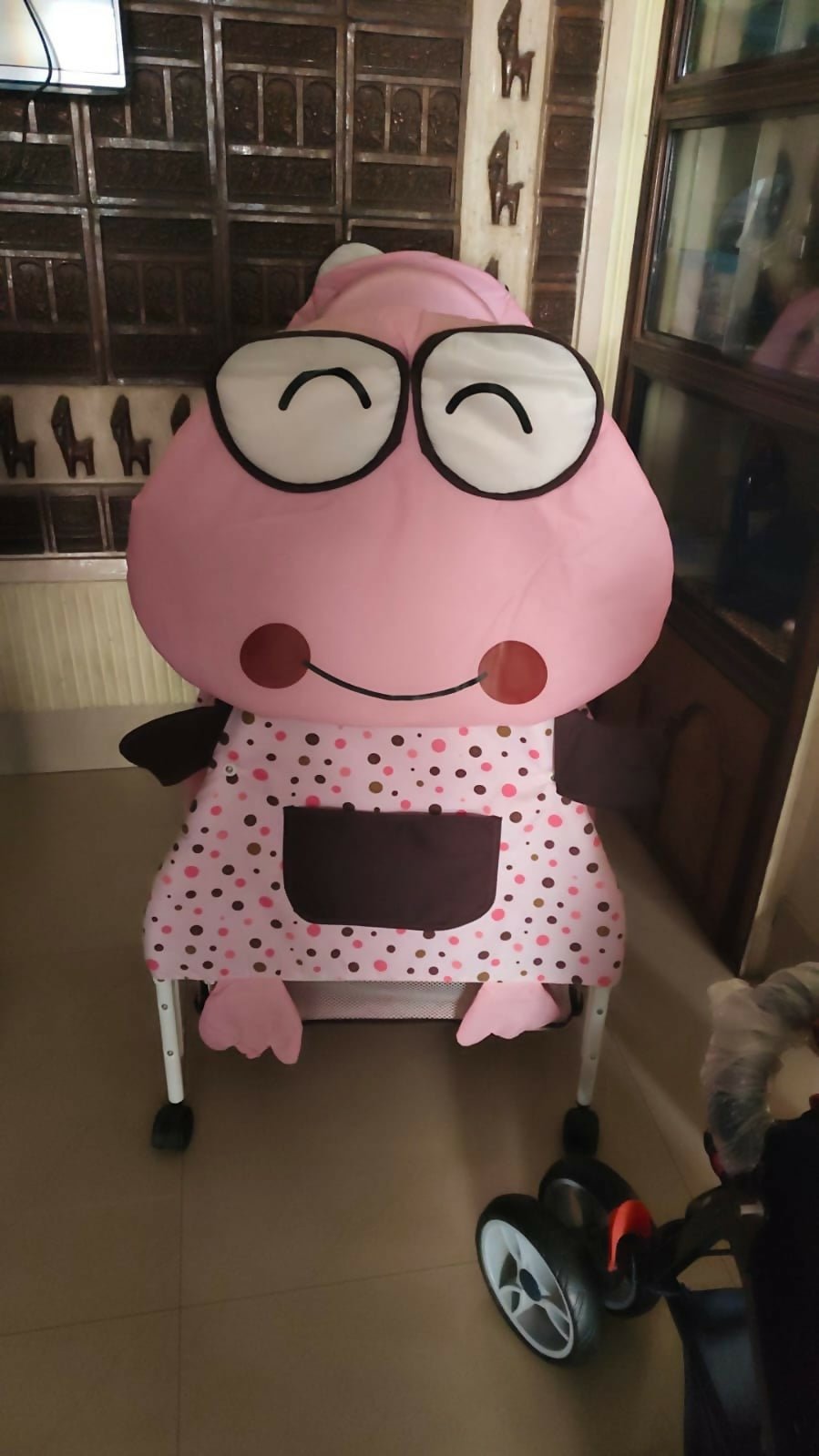 BABYHUG Froggy Print cradle with soft bedding, protective mosquito net, swing lock function, sturdy frame, and adorable frog print for a safe and comfortable sleeping space for newborns.