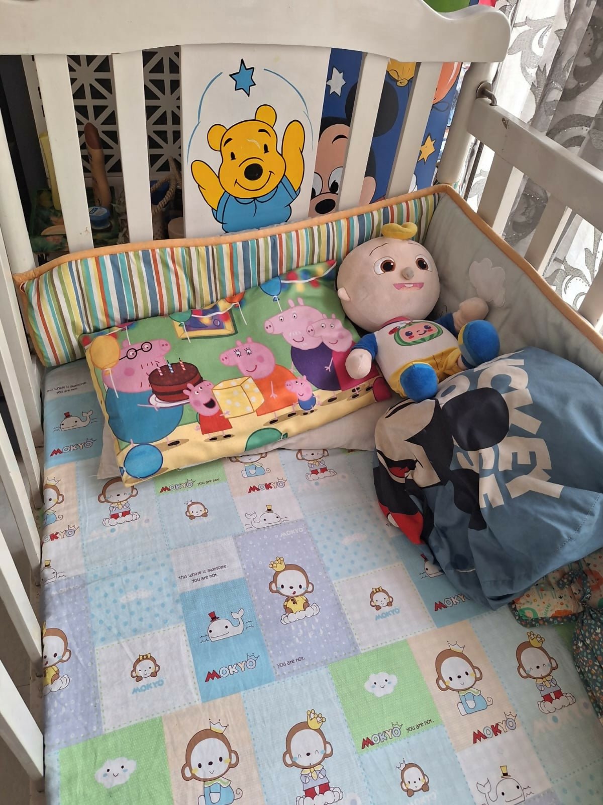 Wooden baby crib with storage, mattress, and bumper featuring sturdy wooden construction, spacious sleeping area, built-in storage, protective bumpers, and comfortable support for babies.
