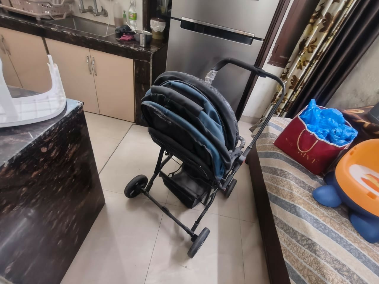Baby stroller/pram with a foldable design, reclining seat, adjustable canopy, 5-point safety harness, smooth wheels, and spacious storage basket for safe and comfortable travel with babies and toddlers.