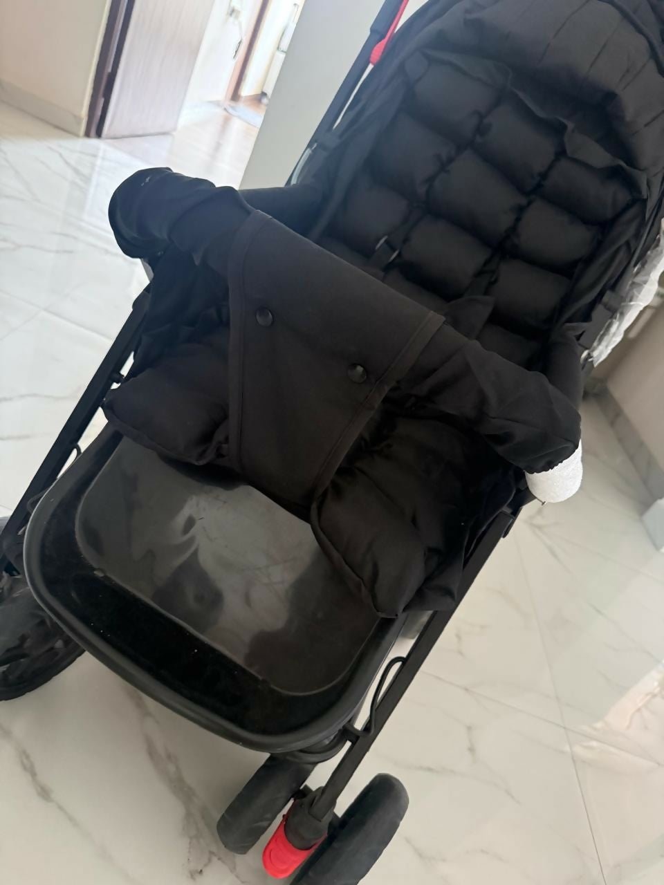 BABYHUG Cocoon stroller/pram with a reclining seat, foldable dacesign, adjustable canopy, 5-point safety harness, smooth wheels, and storage basket for comfortable travel with babies and toddlers.