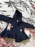 Blue baby sweater with soft knitted fabric, cozy warmth, comfortable fit, and classic design for everyday wear during cooler weather.