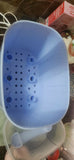 Blue colander with holes on a brown surface