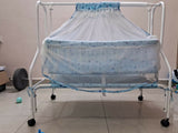 Baby crib with blue canopy on a tiled floor