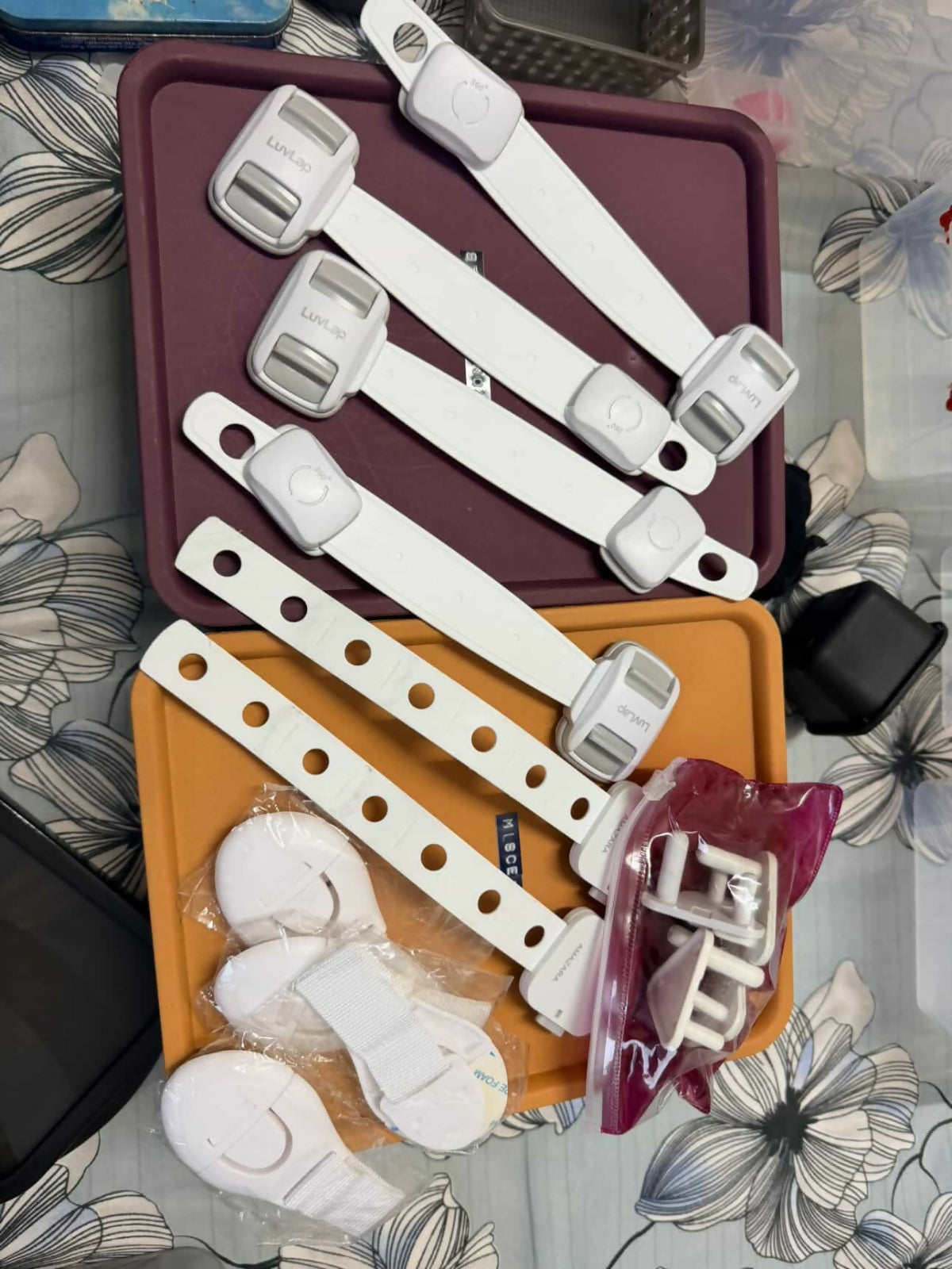 Set of plastic straps and buckles on a floral-patterned surface