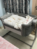 Chicco Next2Me Magic Eco co-sleeping crib with adjustable height, breathable mesh sides, drop-down side panel, lockable wheels, and a comfortable mattress for safe bedside sleeping.
