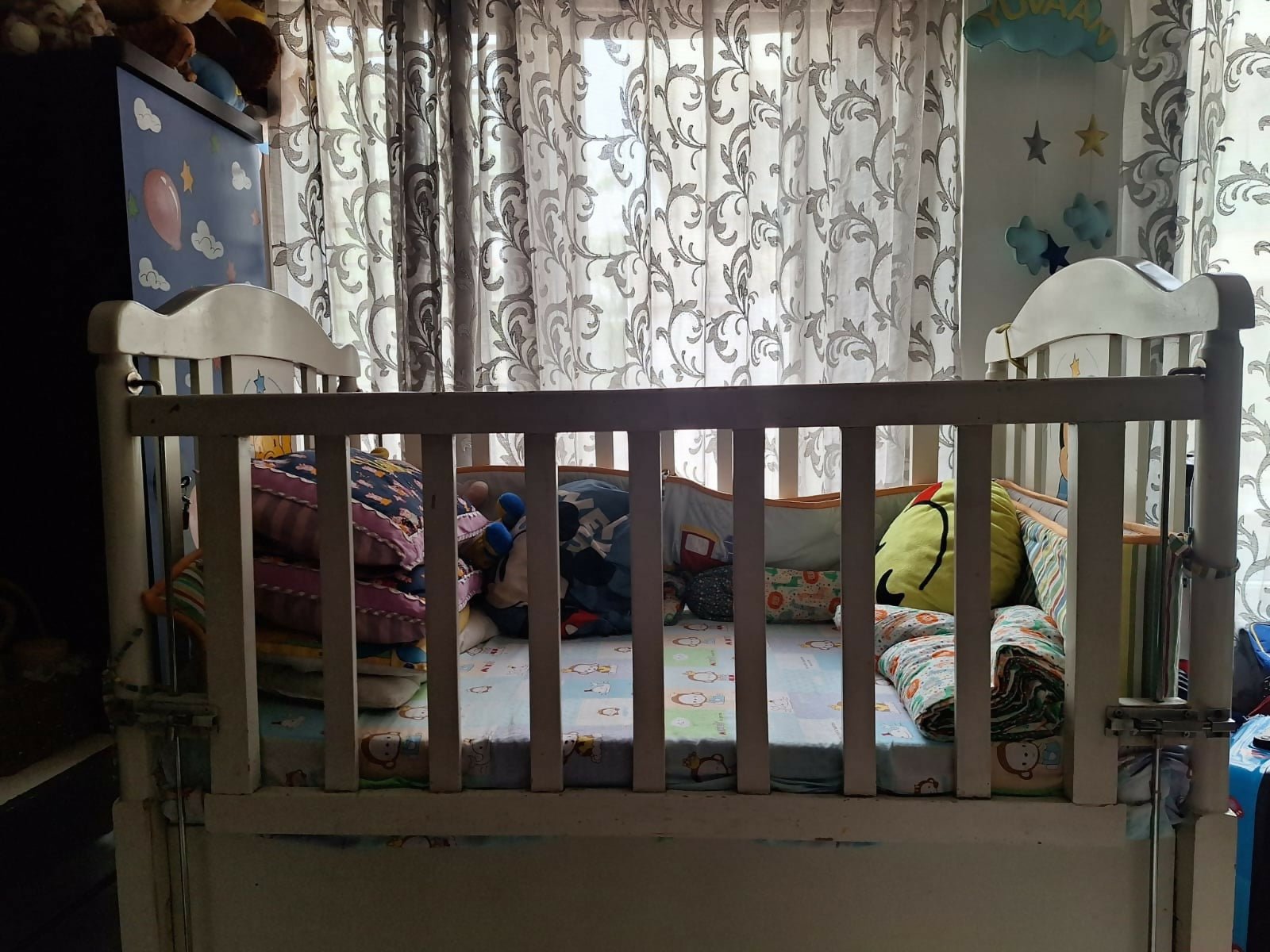 Wooden baby crib with storage, mattress, and bumper featuring sturdy wooden construction, spacious sleeping area, built-in storage, protective bumpers, and comfortable support for babies.
