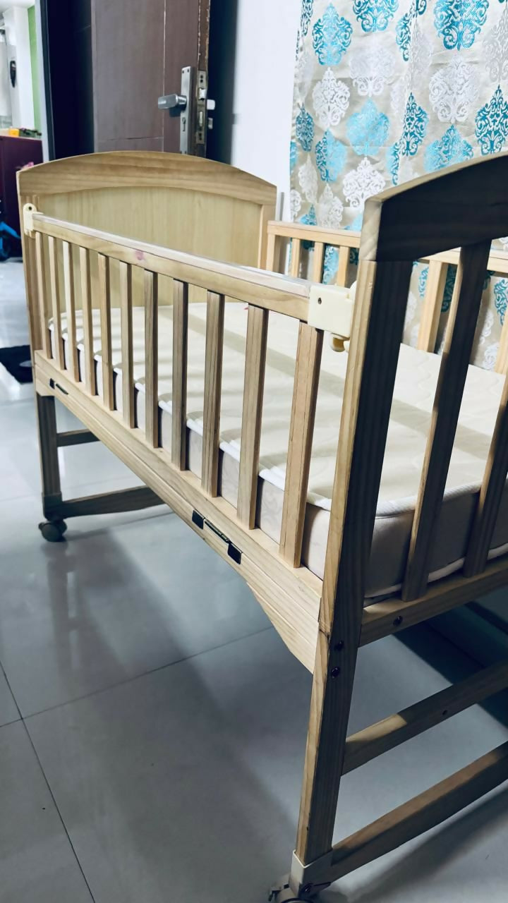 BABYHUG 4 in 1 convertible baby cot with rocking function, cozy sleeping space, sturdy frame, adjustable design, and rocking feature for baby comfort and safe sleep.