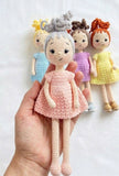 Handcrafted crochet baby doll soft toy with curly hair, soft yarn construction, detailed stitching, and a cuddly design for babies, kids, gifting, and nursery décor.