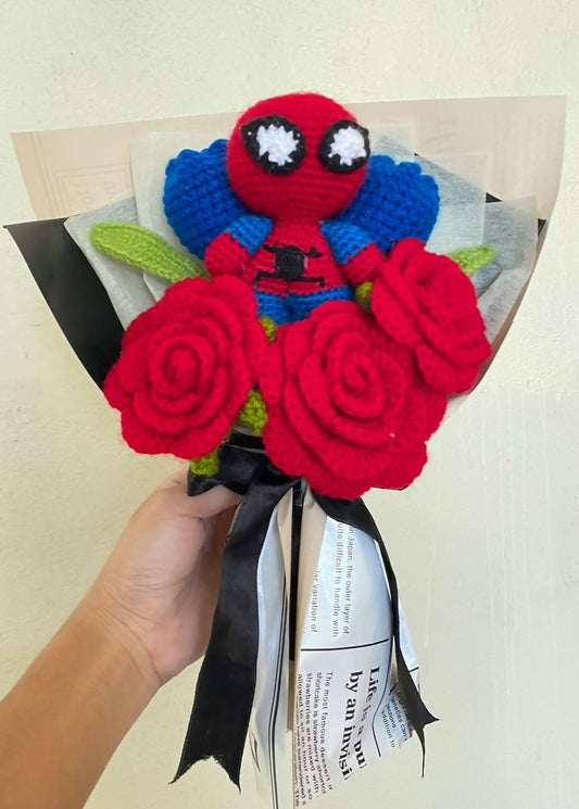Bouquet made of red roses and a Spider-Man figure held by a hand on a light background.