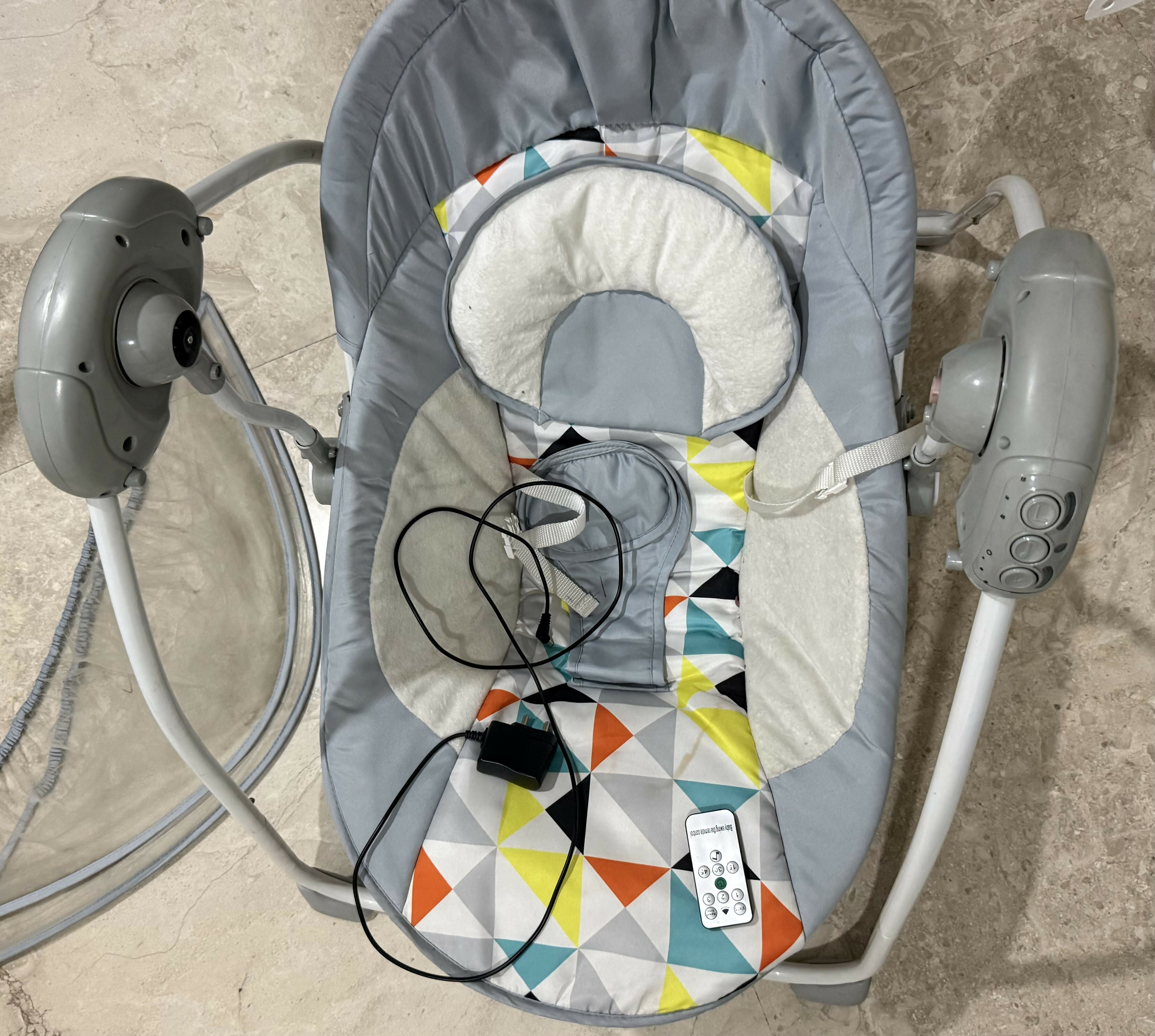 Electric baby swing with music featuring gentle swinging motion, cushioned seat, soothing melodies, secure harness, and comfortable support for baby relaxation and sleep.