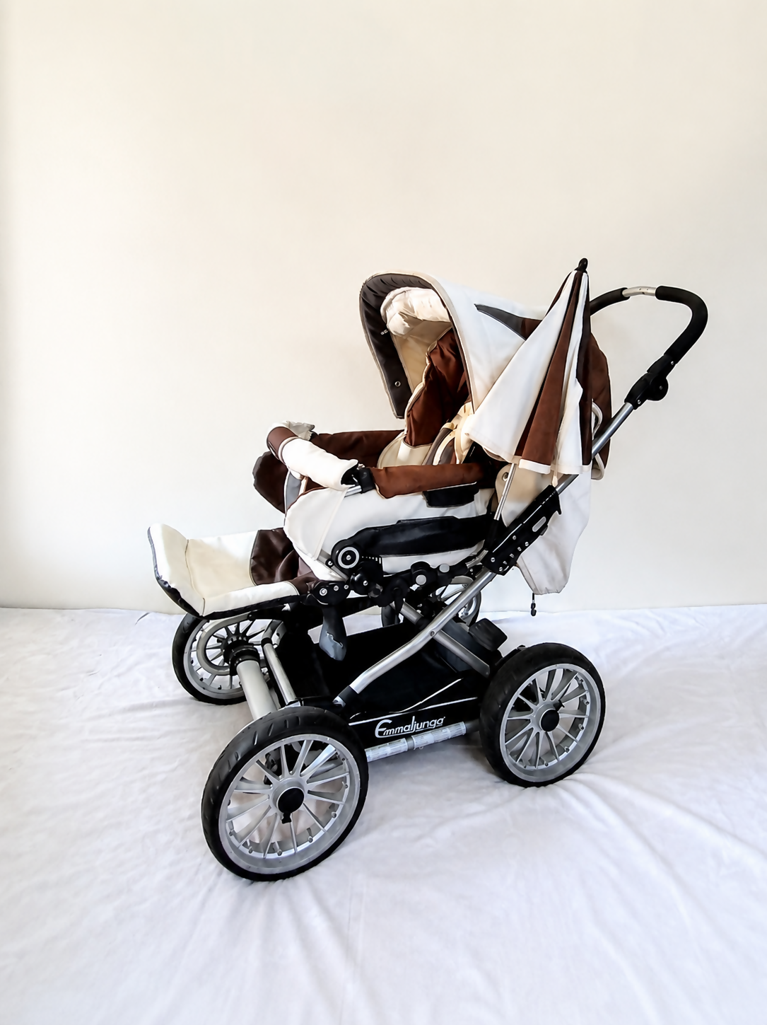 Emmaljunga City Cross Premium Stroller B128 in Almost New condition, available in Chennai, Tamil Nadu, featuring a reversible seat, comfortable reclining design, protective canopy, rain cover, sturdy frame, and smooth wheels.