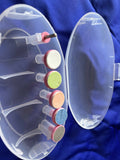 Clear nail drill with colored attachments on a blue background