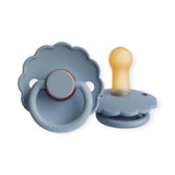 Two blue baby pacifiers with wooden and silicone parts on a white background