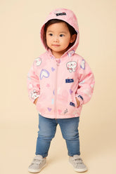 Child wearing a pink hoodie with cartoon designs