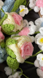 Close-up of crocheted flowers in various colors