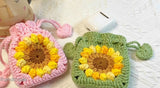 Two crocheted pouches, one pink and one green, with a sunflower pattern