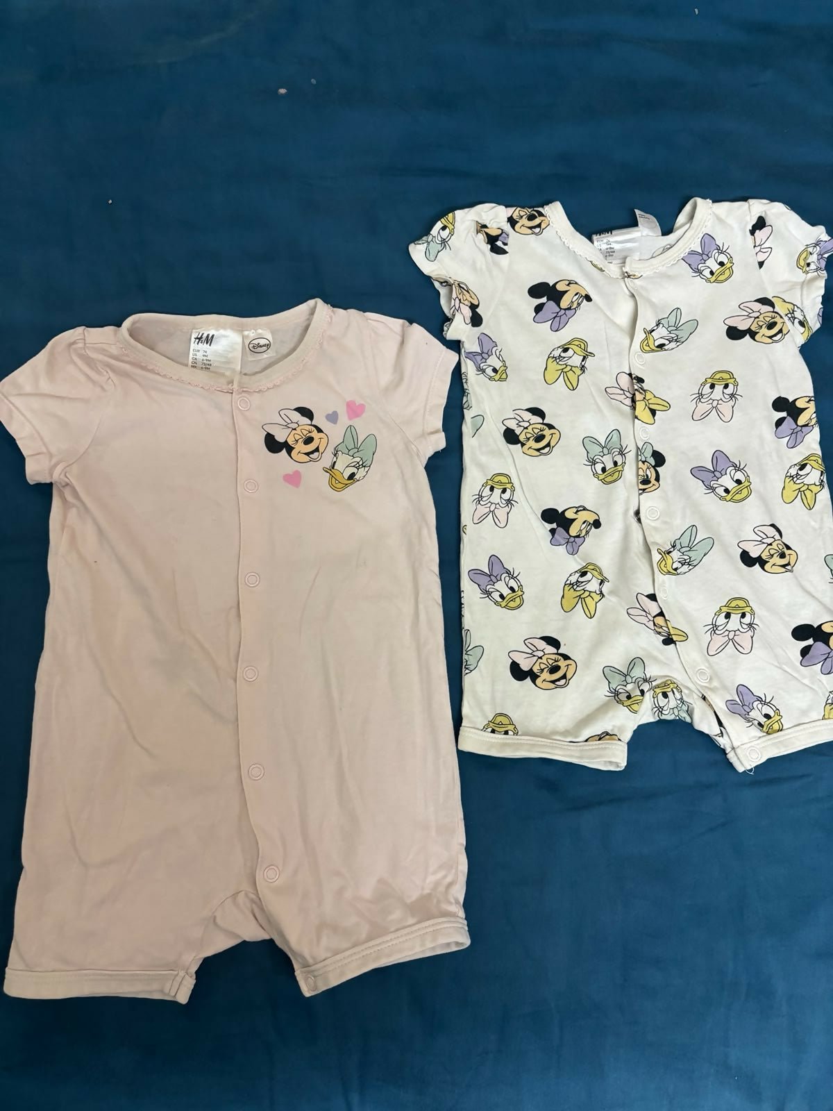 H&M Disney Collection 2-pack cotton rompers featuring soft breathable fabric, comfortable fit, easy wear design, and playful character-inspired prints for babies and toddlers.
