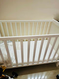 IKEA SUNDVIK Baby Cot in White with mattress and mattress protector, featuring a sturdy wooden frame, adjustable mattress height, classic design, and a safe, comfortable sleeping space for babies.
