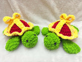 Two green turtles with red hearts and yellow crowns on a white background