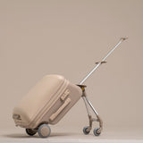 Beige suitcase with a retractable handle on a beige background
