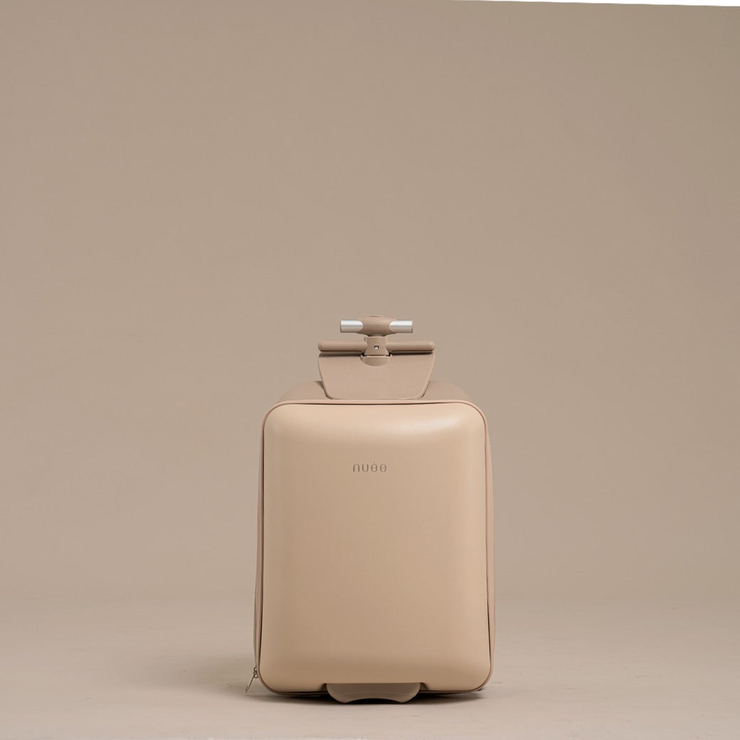 Beige suitcase with a handle on a beige background