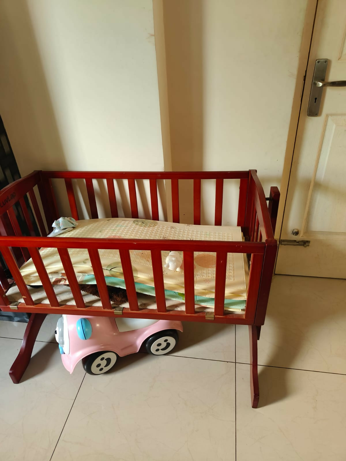 LuvLap wooden cradle with a sturdy wooden frame, gentle rocking motion, protective side rails, and a spacious sleeping area for safe and comfortable rest for newborns and infants.