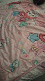 Baby blanket in pink with cute print, soft cozy fabric, lightweight feel, and comfortable warmth for newborns, babies, and everyday use.