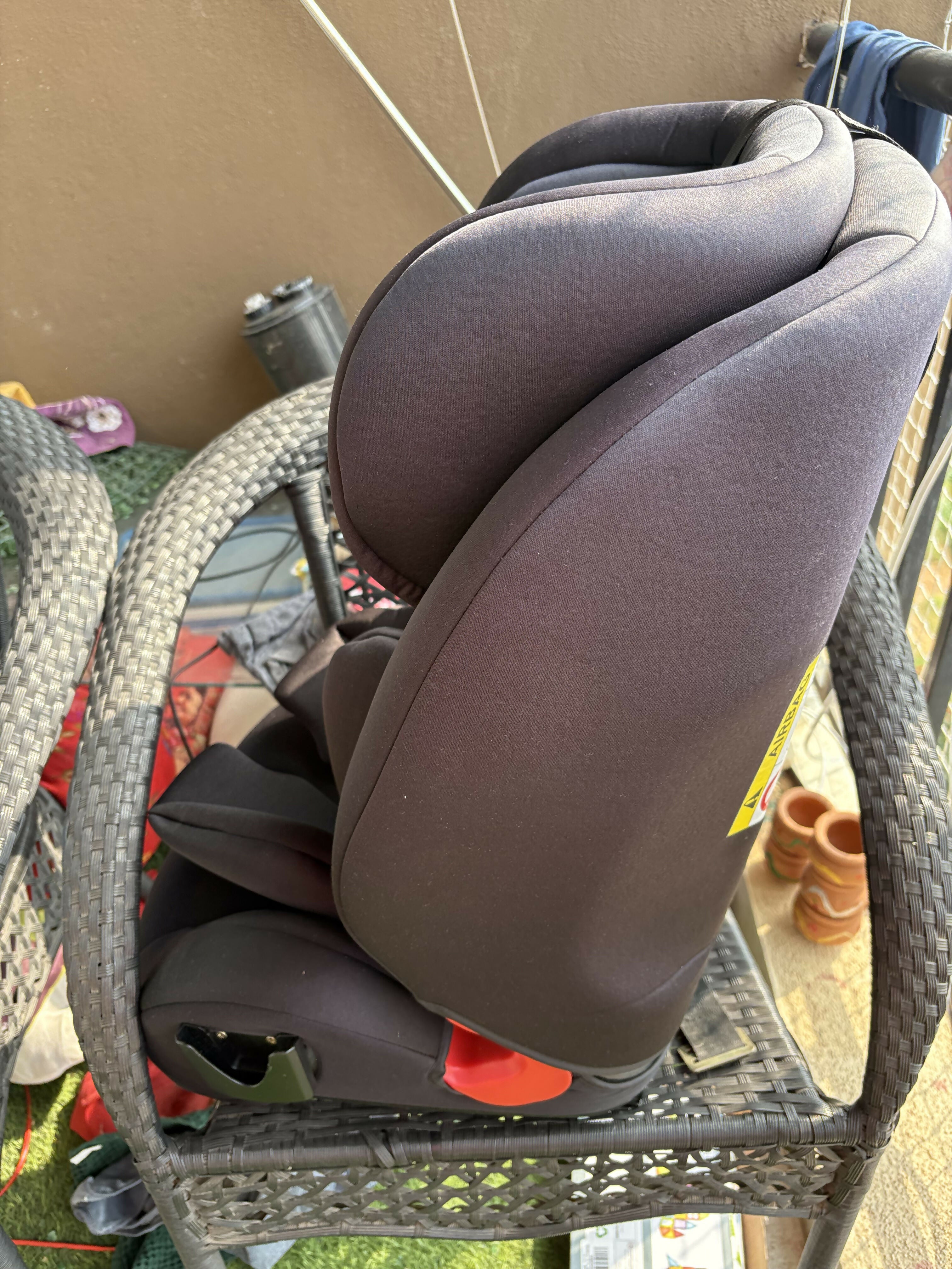 Child's car seat on a chair outdoors